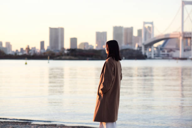 Businesswoman walking on the beach