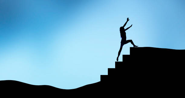 istock Silhouette of a woman climbing a staircase step 1451438256