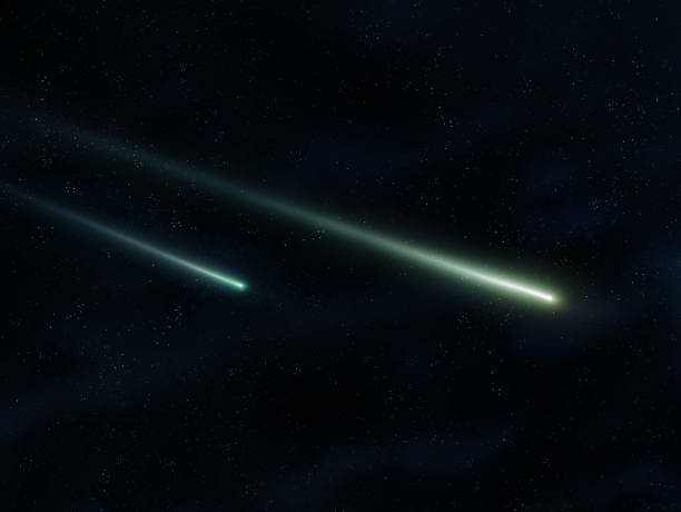 istock Two meteors glow in the night sky. Shooting stars on a dark background. 1451438954