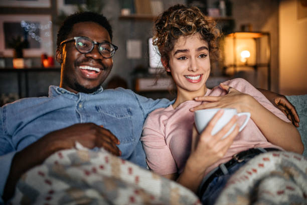 istock Multiracial loving couple watching tv in the evening 1451441193