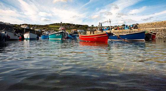 Aerial top view of fishing boats in the blue sea.