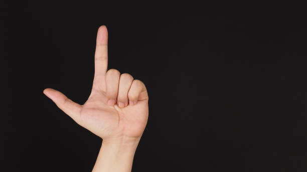 istock Looser hand sign on black background. 1451442360