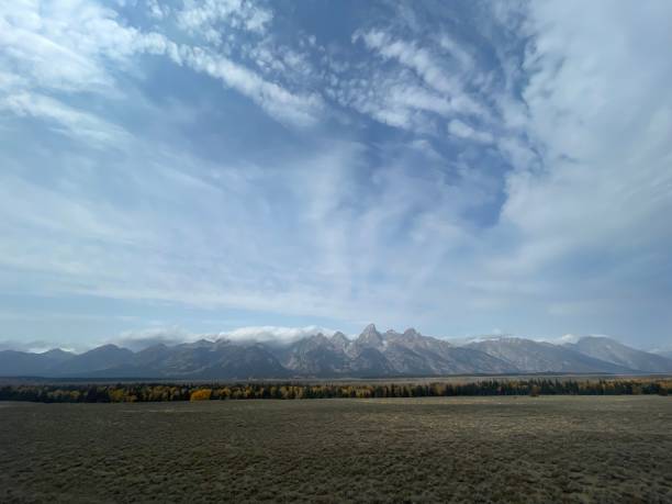 istock Scenic view of a mountain range under bright blue sky 1451447154