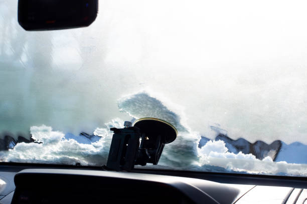 istock Frozen windshield in the car, view from the passenger compartment. Warming up the car in winter 1451450936