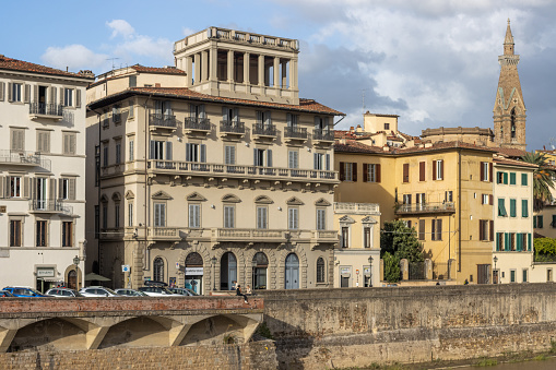 Palazzo Bargagli on Lungarno delle Grazie at Florence in Tuscany, Italy. People are visible in the distance.