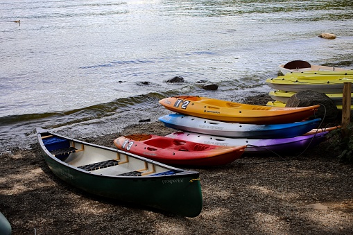 Lake Windermere, United Kingdom – July 25, 2018: A group of canoes on a Lake Windermere coast