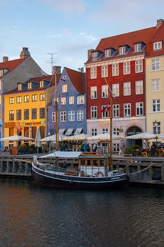 Copenhagen, Denmark – October 12, 2022: A vertical shot of colorful houses in waterfront district of Nyhavn