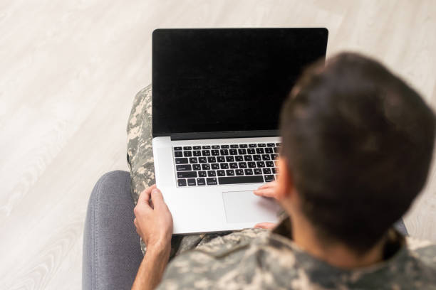 istock military man in uniform looking at laptop 1451462595