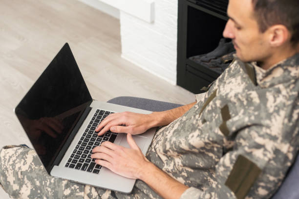 istock military man in uniform looking at laptop 1451463301