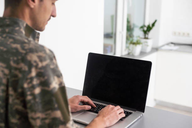 istock military man in uniform looking at laptop 1451464051