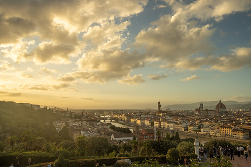 Sunset over Florence in Tuscany, Italy, with people visible on Michelangelo Piazza.