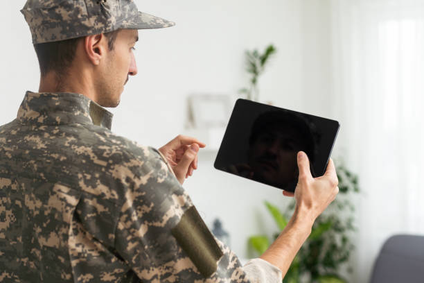 istock Male soldier using tablet computer on white background. Military service 1451465585