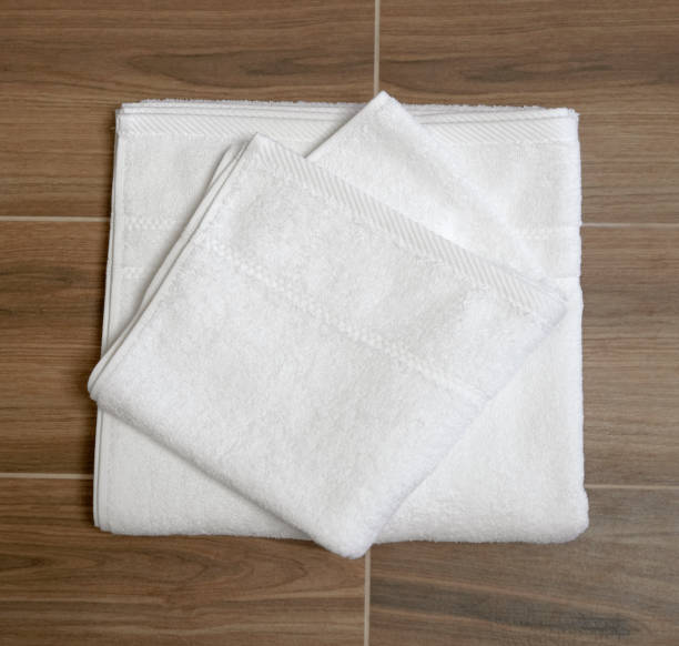 istock Folded white terry towels on a wooden table 1451465840