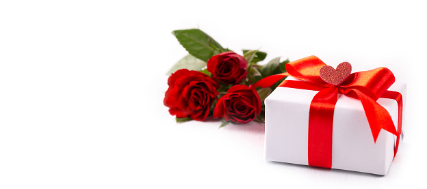 Rose bouquet on grass with gift box and space for copy. Mother's Day background