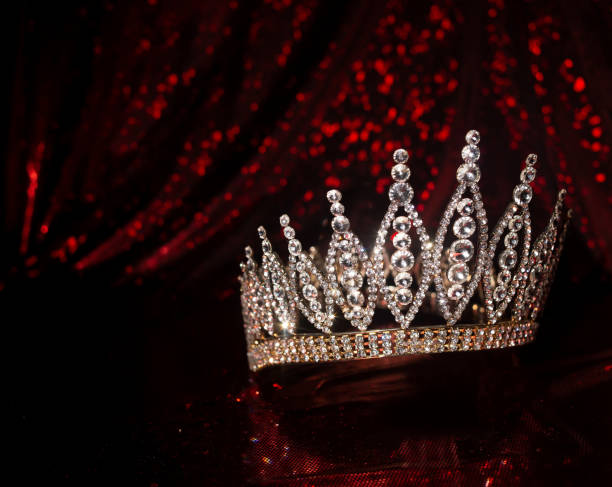 istock Royal crown on luxury satin, silk fabric background 1451469000