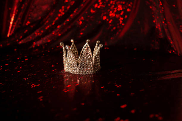 istock Royal crown on luxury satin, silk fabric background 1451469018