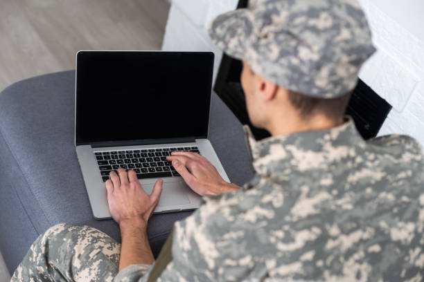 istock military man in uniform looking at laptop 1451469208