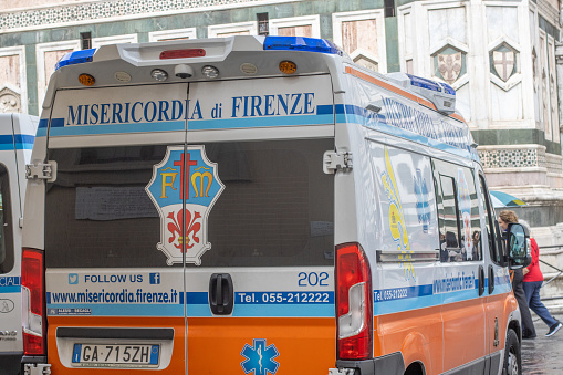 Ambulance at Piazza del Duomo in Florence in Tuscany, Italy, with a car number plate visible.