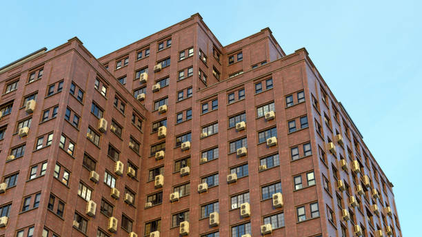 istock apartment building red brick corner windows with air conditioning condominium old architecture 3D illustration 1451476075