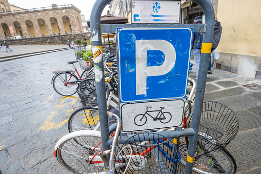 Parking Sign at Piazza del Duomo at Florence in Tuscany, Italy, with many commercial stickers visible.