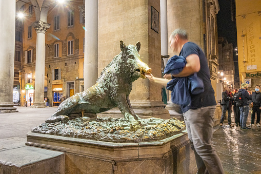 A man places a coin in the mouth of the wild boar to ensure his return to Florence. Next she will rub the snout to guarantee good luck. That's why the snout has the striking white appearance - because it’s constantly rubbed by tourists. Il Porcellino (which means 'piglet' in Italian) is the name for this bronze fountain. It was designed by Pietro Tacca (1577-1640) in about 1634. The original; statue represents the Calydonian Boar of Greek myth. It's located at the Mercato Nuovo.