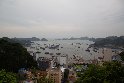 Cat Ba Island is a beautiful small island with a small town embedded in the middle of the impressive karst landscape that makes up the famous Ha Long bay, Vietnam  (daytime view)