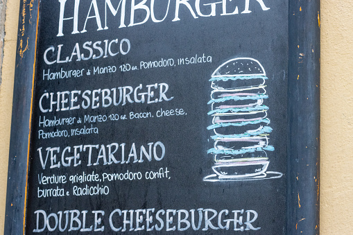 Cheeseburger on Menu at Florence in Tuscany, Italy, with a design element visible.