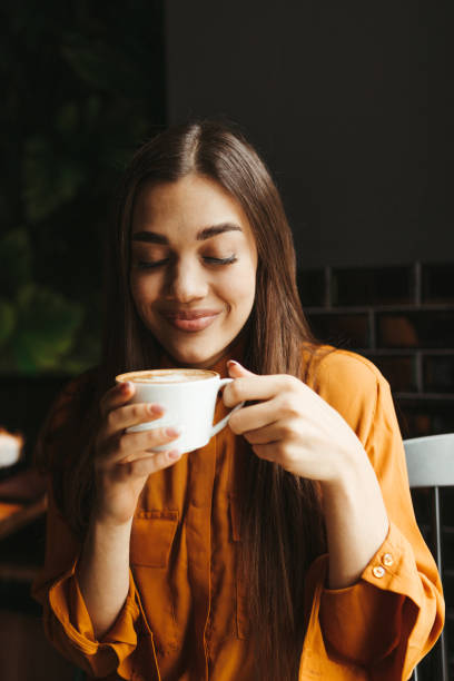istock Young woman drinking first morning coffee 1451480699