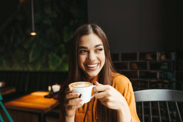 istock Young woman drinking first morning coffee 1451480707