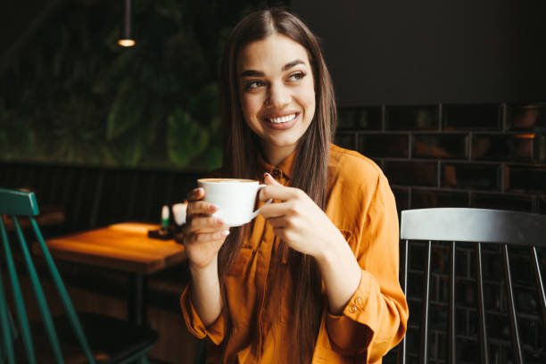 istock Young woman drinking first morning coffee 1451480747