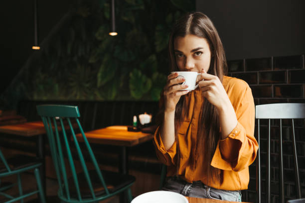 istock Young woman drinking first morning coffee 1451480761
