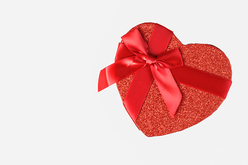Red heart-shaped box for Valentine's Day, with white background to give as a gift.