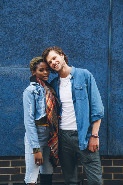 istock Couple embracing agains a blue wall 1451480858