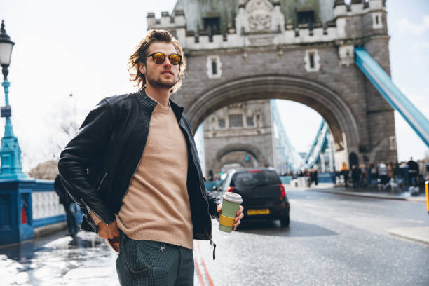 istock Young man crossing the street 1451481398