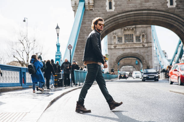 istock Young man crossing the street 1451482677