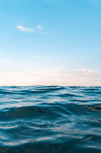 Photography from the surface of the sea, towards the horizon. Calm blue sea without clouds