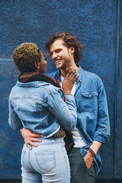 istock Couple embracing agains a blue wall 1451484526