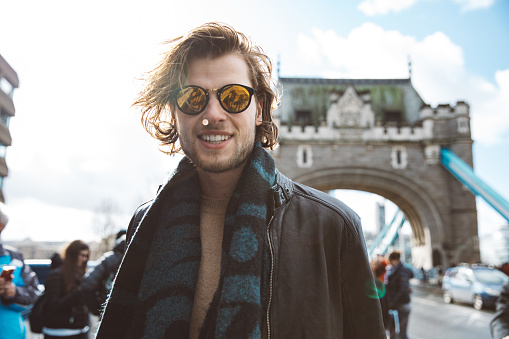 Young fashionable man portrait in the city street.