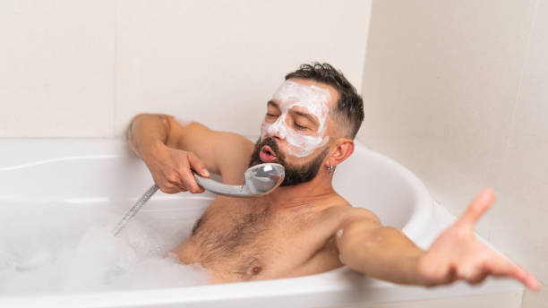istock man with face mask relaxing in bath at home 1451488928