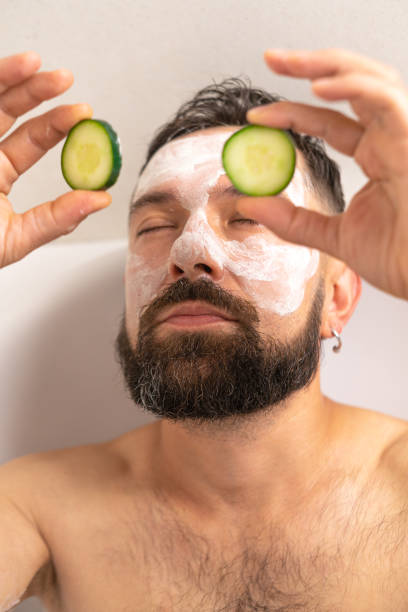 istock man put on cucumber on face in bath at home 1451489110