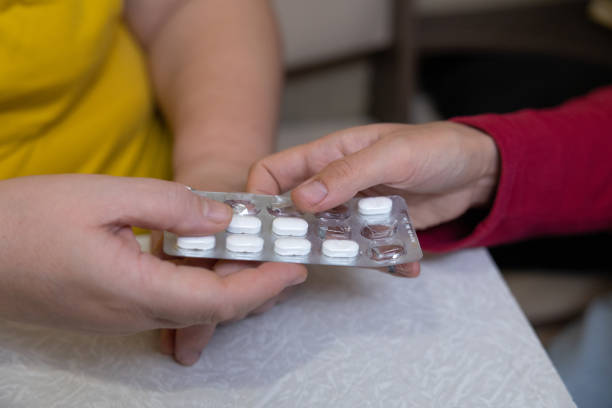 istock The woman takes pills from her daughter's hands. 1451491322