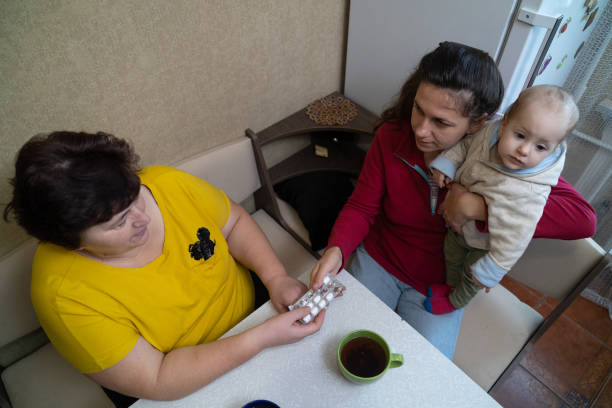 istock The woman takes pills from her daughter's hands. 1451491352