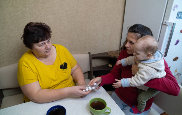 istock The woman takes pills from her daughter's hands. 1451491353