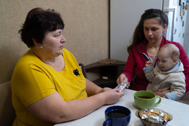 istock The woman takes pills from her daughter's hands. 1451491357