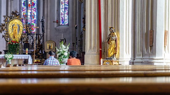 Bavaria, Germany-July 2018: Interior view of a local catholic church, a place of worship, with statues and decorations of religious symbols. House of peace and god.