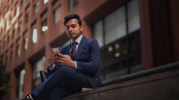 istock Handsome businessman using smart phone in city 1451498092