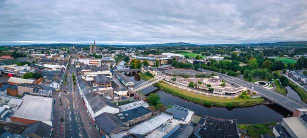 istock Aerial view of cityscape Omagh surrounded by dense trees 1451501045