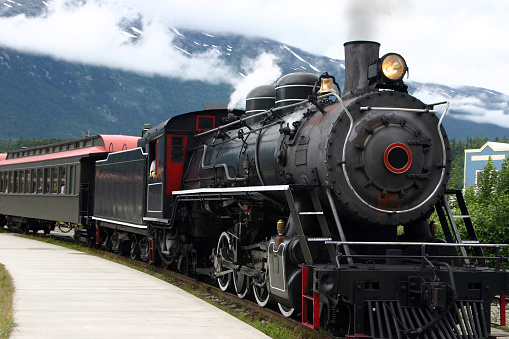 Skagway, Alaska - July 30, 2023: Tourists are enjoying the view from train. White Pass Summit excursion tour train, Alaska, USA.