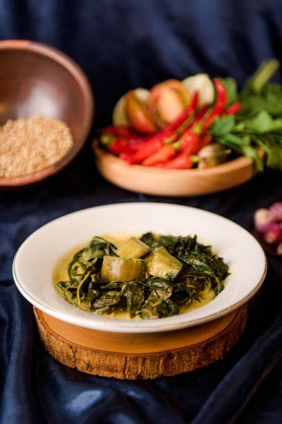 istock Cassava leaf curry is a traditional Indonesian dish, made from boiled cassava leaves, sliced, given coconut milk and spicy curry spices 1451509408