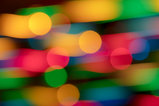 Motion blurred multi colored lights background with beautiful bokeh. Dynamic image.